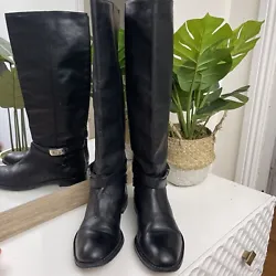Elevate your style with these black knee-high riding boots from Coach. Made from high-quality leather, these pre-owned...