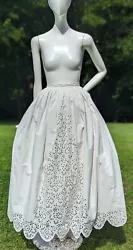 FASHIONED OF WHITE LINEN THAT IS THIN AND FINE AND IS FULLY HAND SEWN THROUGHOUT WITH HAND EMBROIDERED FLORAL PATTERN...