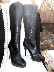 With stiletto brown sexy heels. The boots are crafted of black patent leather upper. Boots are 19