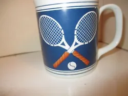 Coffee mug standard size with a pair of tennis racquets and a ball.  Nice gift in unused condition.