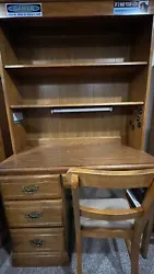 Wooden desk with Hutch and Attached Light.  Comes with 4 drawers, a detachable hutch with two shelves, and a chair. ...