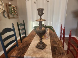 This looks to be an antique Persian lamp. Really, I know next to nothing about it. Its metal with an engraved floral...