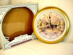 Thomas Kinkade Painter of Light Christmas Carol round wall clock. Plays 12 traditional Christmas carols at the top of...