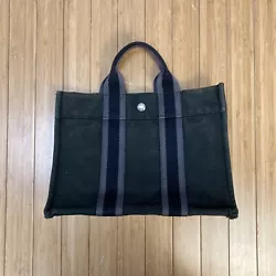 Bag is an overall grey (slightly greenish)color with a black strap with a grey stripe along it down the center of the...