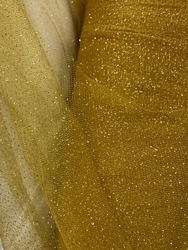 A beautiful, dark gold, tulle fabric with gold sparkles/glitters. 100% polyester. High quality. Sold by the yard. (1...