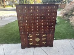 A beautiful vintage Chinese medicine cabinet with 63 small drawers, 9 larger ones and the central large storage space....