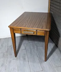 Solid wood with a retro Formica top. Note - there is no drawer on this table - it is a faux drawer front. 20