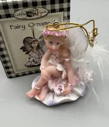Christmas ornament by Cobble Creek, a fairy sitting on flowers wearing a tiara.    Refer to photos for details....