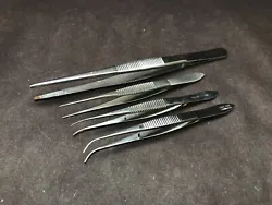 Good used condition. Lot of 4 includes: one 5 1/2” x 2.6mm straight tip serrated tweezer, two 4” curved 0.8mm tip...