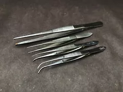 Good used condition. Lot of 4 includes: one 5 1/2” x 2.6mm straight tip serrated tweezer, two 4” curved 0.8mm tip...