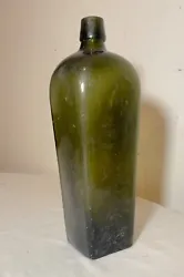 Up for sale is a wonderful antique early 19th century green glass gin bottle. Its mold blown by hand out of thick olive...