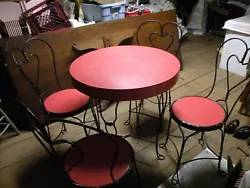 The set has 4 wrought iron chairs and a round wrought iron table with Formica top. Chair 34 3/4