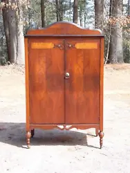The doors also have carved applied details and open to a top shelf above 3 drawers and bottom cubby, next to a long...