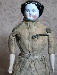 This is a Antique Center Part China Shoulder head doll. Her body is cloth and could be her original.