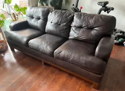 Ashleys Brown Leather Couch Sofa. Condition is New. Local pickup only.