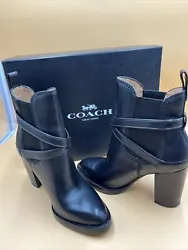 Elevate your style with these timeless black leather boots from Coach. The mid-calf shaft style, round toe, and block...