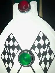 MUDFLAP IN WHITE WITH BLACK & WHITE CHECKERED CROSS FLAGS AND GREEN JEWEL. YOU GET ONE MUDFLAP IN WHITE. WITH CHECKERED...