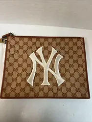 Up for sale is a Gucci MLB NY Yankees GG Supreme Clutch Pouch Brown Brand New. The pouch is brand new and has been kept...