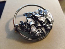 There are quite a few artistic types in the family so I cant guess either. The pin tests sterling but is not stamped or...