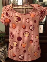 It is from the Disney collection. It is a size Small. This Classic T is whimsical! It is pink with white polka dots....