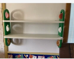 Sports Book Shelf (or Knick knacks, Trophies) Baseball, Football & Basketball Twirling decorations on both ends....