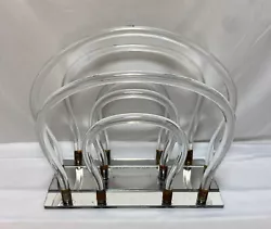 Vintage lucite and mirrored base magazine rack. It is 13