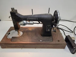 Light works. Pedal works makes motor spin but Sewing Action doesnt move with pedal. Manual Wheel is very tight...