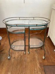 Wonderful Deco Bar Cart. It is Brass and Glass. It has swing out side shelves for multi purpose use. Very dramatic...