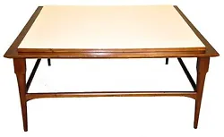 Lovely Mid-Century Modern coffee table with the original finish, featuring a raised white formica square top supported...