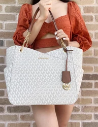 MK Hanging Logo Charm. Interior features: 1 zipper pocket and 2 slip pockets. Zipper closure.