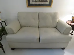 There are two attached cushions on the back of the loveseat sofa. Both the back and seat cushions have attractive...