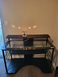 Used, glass top computer desk. In great shape, minus a little wear & tear at the bottom. Has wheels for easy mobility....
