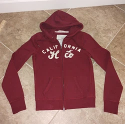 This has a zipper with 2 zippers on it so you can open it from the bottom end when its zipped up. This is a darker red...