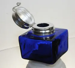 Reproduction antique blue glass inkwell. Each with charming subtle signs of being hand made. The hinged lid is nickel...