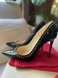 Authentic Christian Louboutin Anjalina Black patented pumps with gold studded spikes in like-new condition. Purchased...