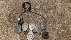These are numbered to help with assembly. (2) Square Sliders with locking pull tabs. (1) original cable. (4) pulleys.