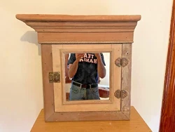 Very sweet little mirror front, built-in cabinet with cubby holes. The crown molding was detached. I added flat...