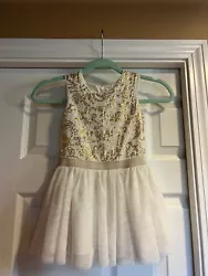 Pretty little dress with gold sequins and a tulle skirt. Excellent condition.