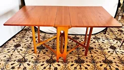 Rare Danish Modern teak dual gate-leg dining table that is nothing short of spectacular. Use for parties as well as a...