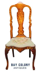 The chair has carved knees and the entire seat box is decorated with matching inlay with floral panels on the front and...