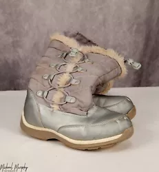 These boots have fur trim (worn from normal use and snow exposure), and laces on the side and top to keep the snow out...