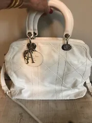 It is a white quilted large Granville Satchel Two way bag by Christian Dior. It has silver hardware. It has just been...