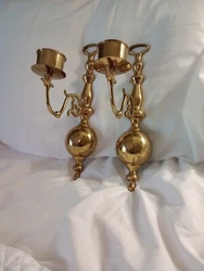 Brass Wall Sconces Set Of 2 Candle holders.  Measures 12 inches tall And arm extends out 6.25 inches These are in good...