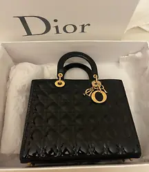 Authentic Christian Dior Lady Dior Bag in Patent Black with Gold Hardware. Condition: in excellent condition with...