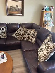 Thisbrown leather sectional couch is a stylish addition to any living room. With a seatingcapacity of 5, it provides...