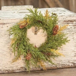 This is a new candle ring wreath of artificial green prickly pine with little pinecones on a grapevine base.