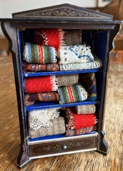 antique Walterhausen Kestner cabinet with linens, The cabinet has been reglued, is sturdy. Dimensions 6 inches tall, 4...