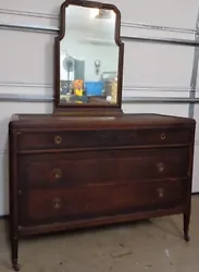 Manufactured by Berkey and Gay, Grand Rapids Mi. Solid wooden 3 drawer dresser with mirror on top, 4 caster wheels on...
