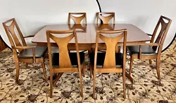 Expandable mid century classic Kent Coffey dining room set that includes table, chairs and one leaf.  The table...