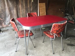 Red Formica top chrome table with matching chairs (3). Middle extension leaf included. Fair condition. Never...